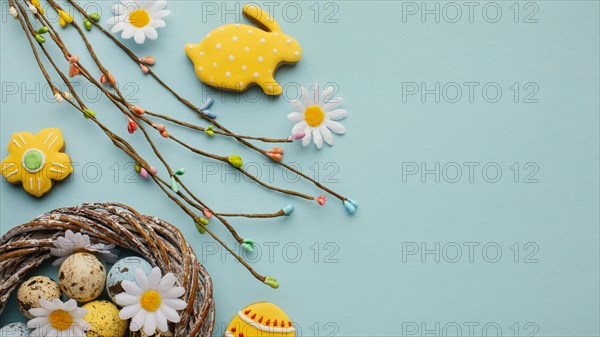 Flat lay easter eggs basket with chamomile flowers bunny