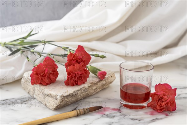 Flowers with glass beside