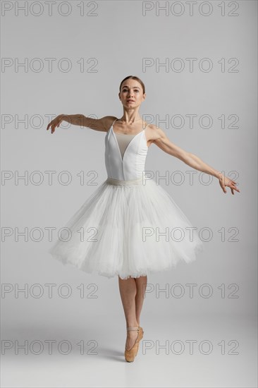 Full shot ballerina standing pointe shoes