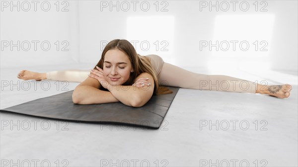 Full shot relaxed woman mat