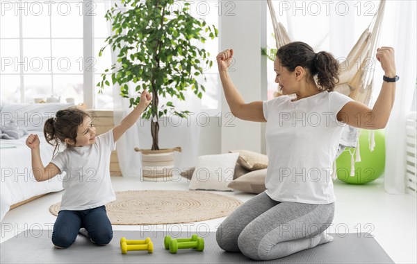 Full shot strong woman kid