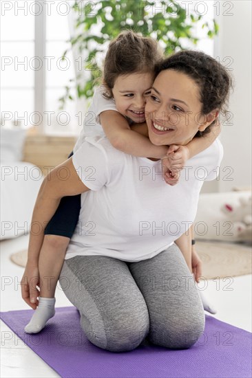 Full shot woman holding girl back