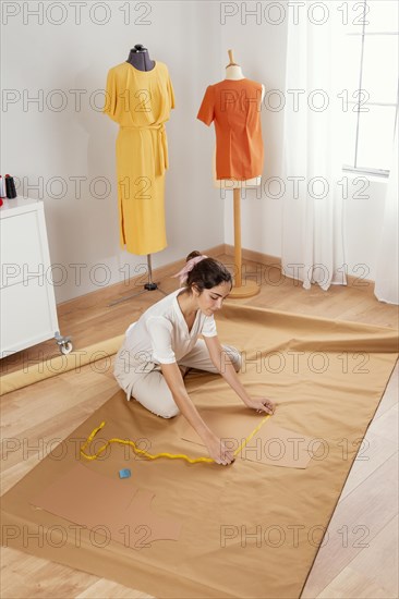 Full shot woman sitting fabric