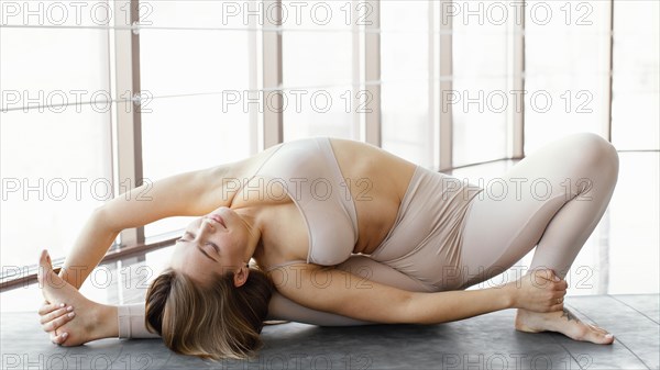 Full shot woman stretching her body