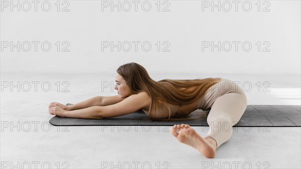 Full shot woman yoga mat