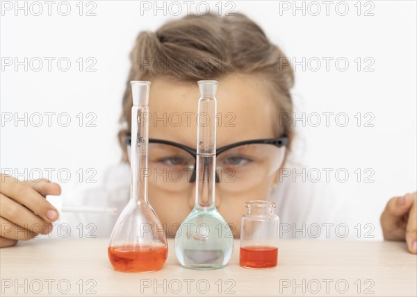 Girl doing chemistry experiments with test tubes
