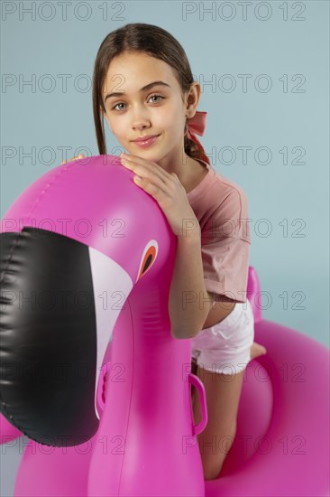 Girl sitting inflatable flamingo