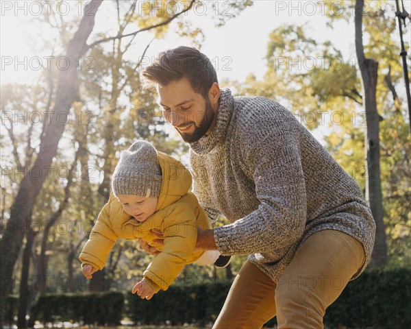 Happy father with baby outdoors