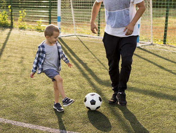 Happy monoparental family playing football