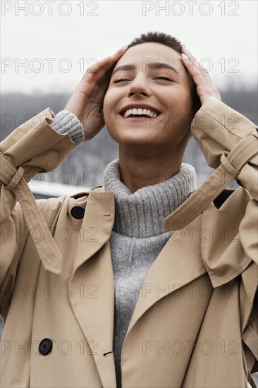 Happy woman posing outdoors medium shot