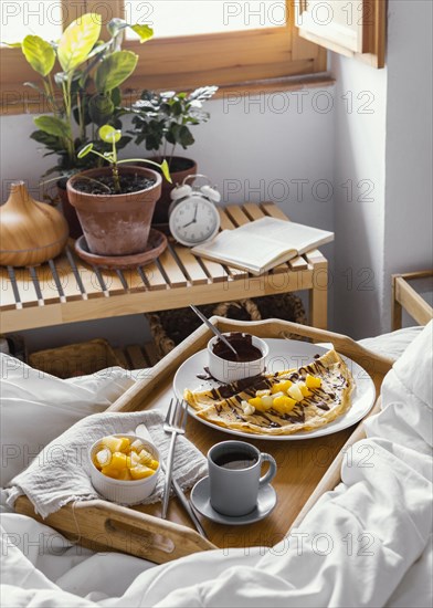 High angle tasty breakfast tray bed