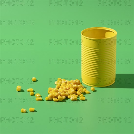 High angle yellow tall round tin can with corn