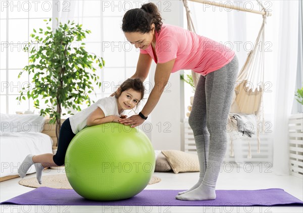 Kid woman training with gym ball