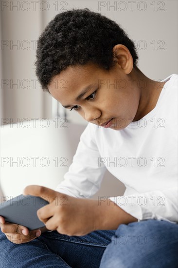 Little boy playing mobile