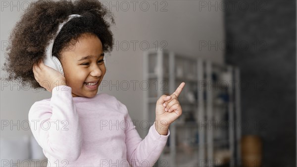 Little girl bed with headphones