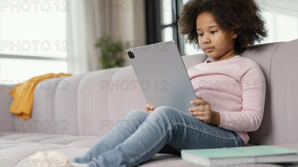 Little girl using tablet home 2