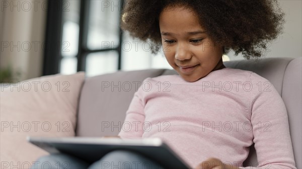 Little girl using tablet home 3