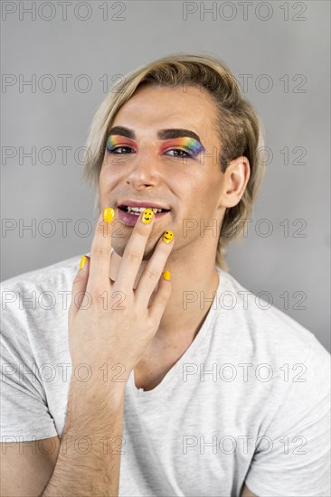 Man wearing make up cosmetics nail polish front view