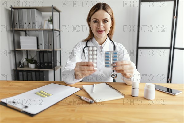 Medium shot doctor holding medicine 4
