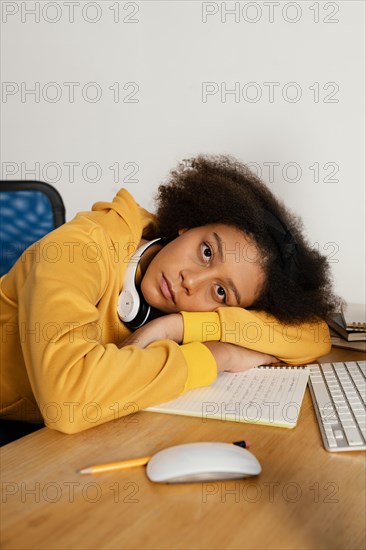 Medium shot girl laying desk