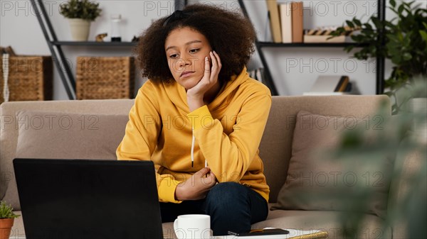 Medium shot girl looking laptop