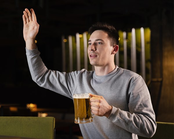 Medium shot man holding beer mug