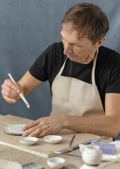 Medium shot man holding brush