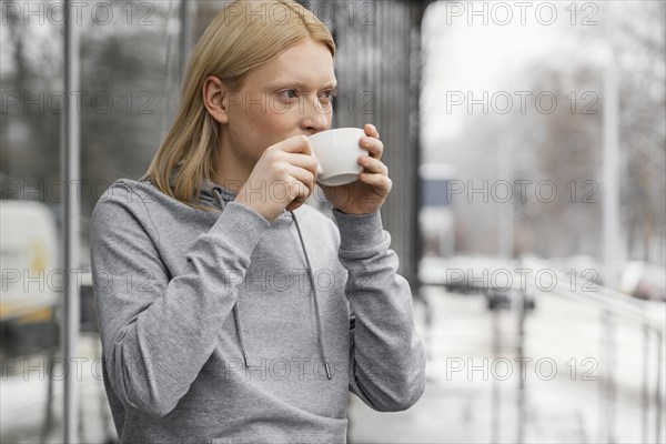 Medium shot woman drinking from cup 3