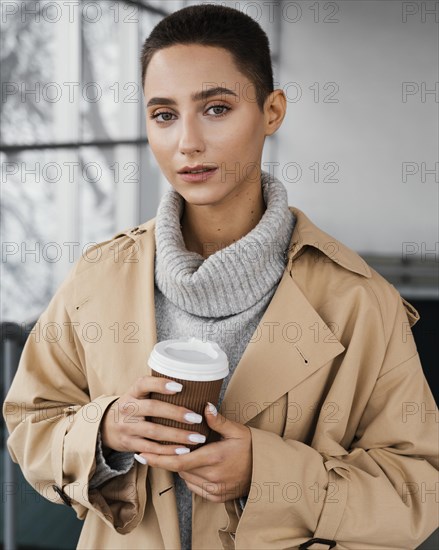 Medium shot woman holding coffee cup