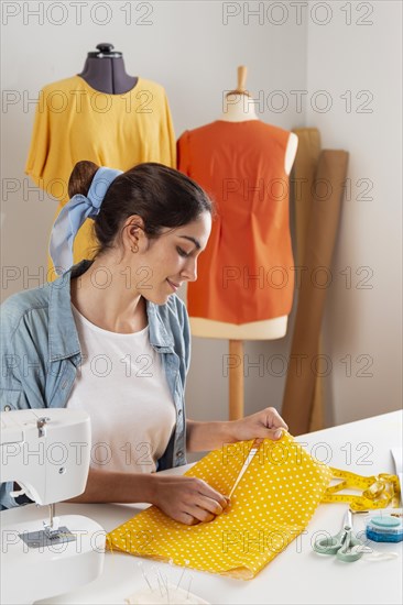 Medium shot woman holding fabric