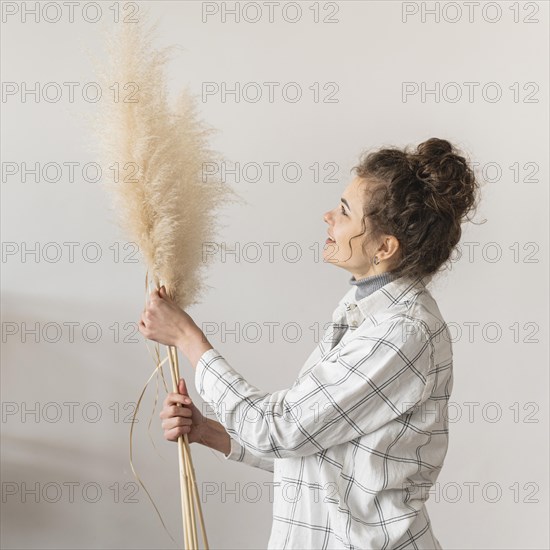 Medium shot woman holding plants