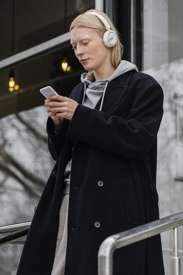 Medium shot woman holding smartphone 3