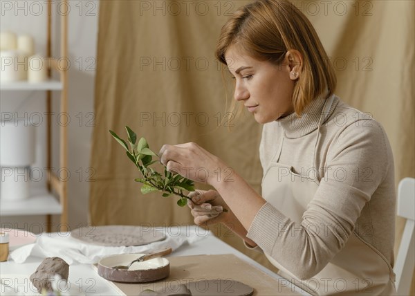 Medium shot woman holding twig