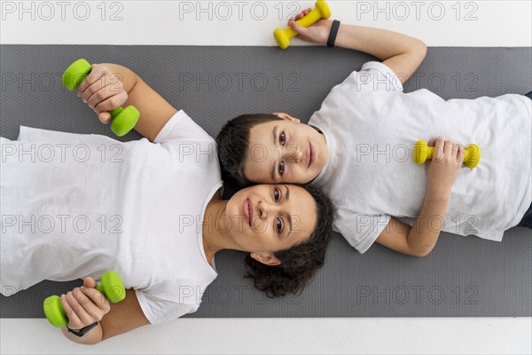 Medium shot woman kid with dumbbells