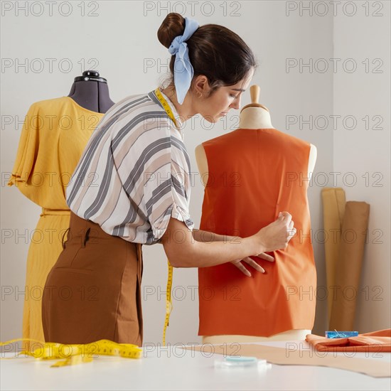 Medium shot woman making clothes