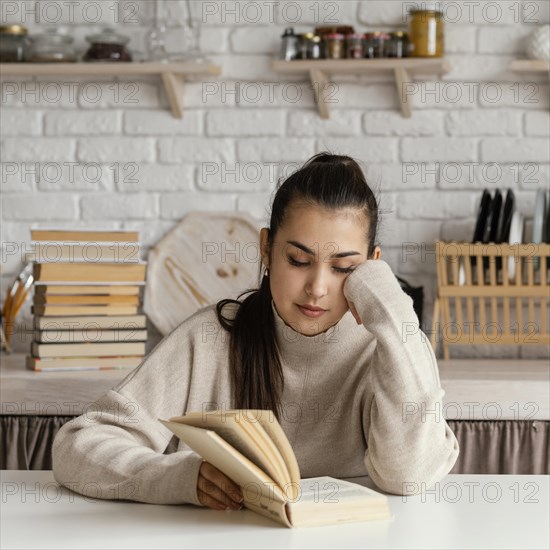 Medium shot woman reading table