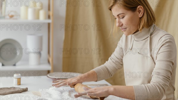 Medium shot woman with rolling pin 2