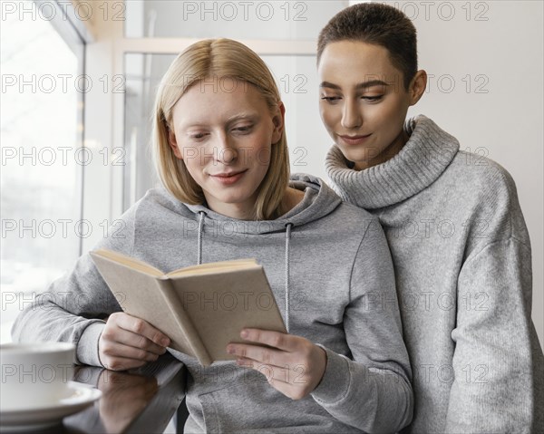 Medium shot women reading together