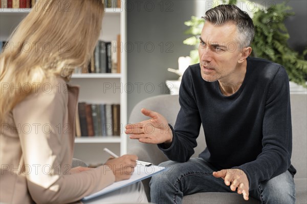 Mid shot man talking woman therapist