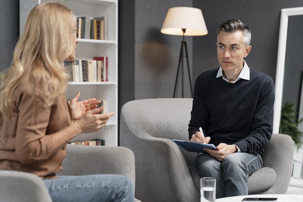 Mid shot woman talking man therapist