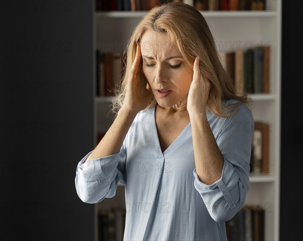 Mid shot woman therapist holding hands head