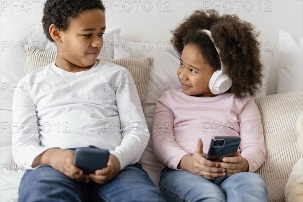 Siblings using mobiles
