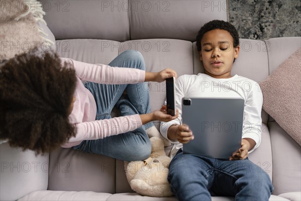 Siblings using tablet mobile home 4