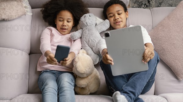 Siblings using tablet mobile home 5