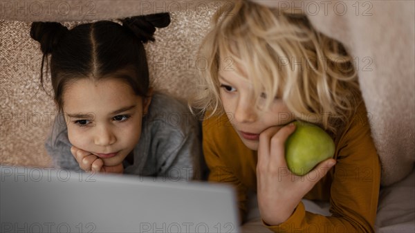 Siblings watching video laptop 2