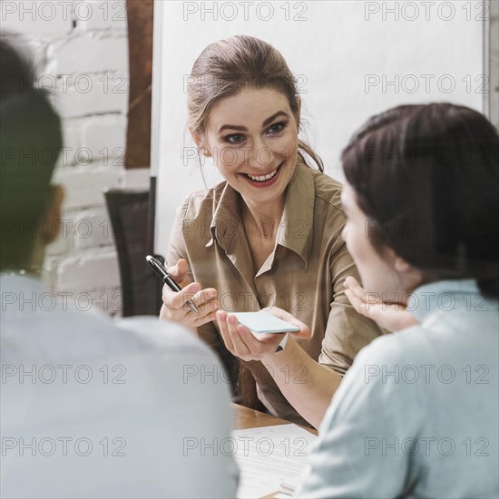 Team young smiley businesspeople during meeting presentation