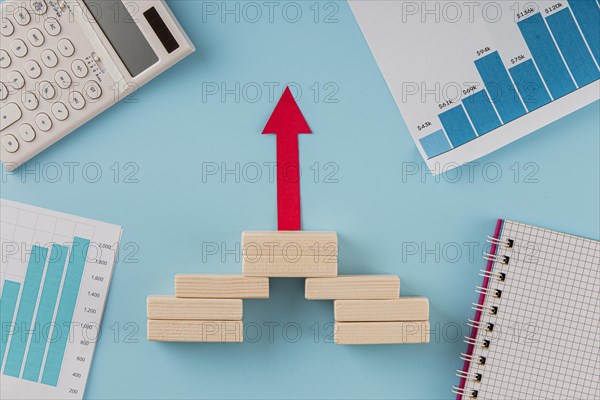 Top view business items with growth chart arrow
