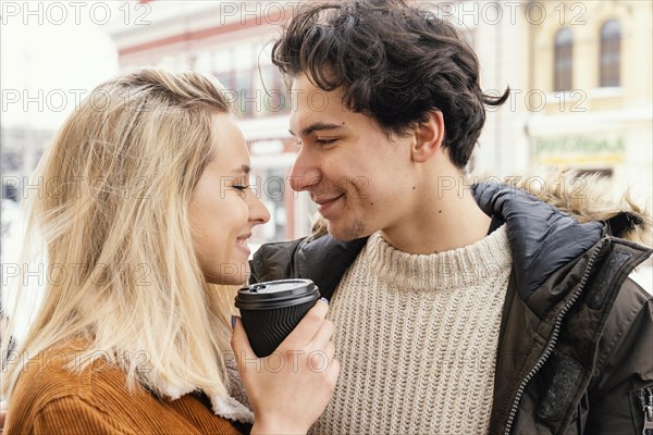 Young couple outdoor enjoying cup coffee 3