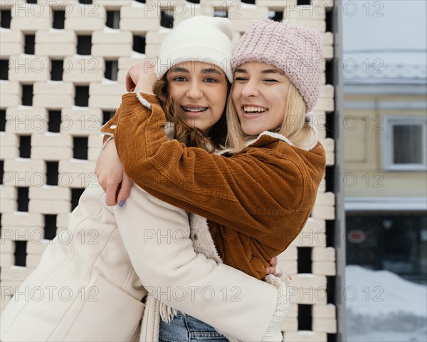 Young girlfriends outdoor hugging 2