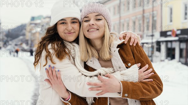 Young girlfriends outdoor hugging 3